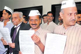 FRESH SALVO: Arvind Kejriwal with his team members in New Delhi