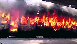 The Hyderabad-Solapur train catches fire at the Gulbarga railway station in Karnataka on Tuesday