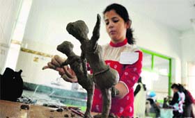 A girl prepares a clay model on the second day of the Panjab University Zonal Youth and Heritage Festival at Ramgarhia Girls College in Ludhiana on Tuesday