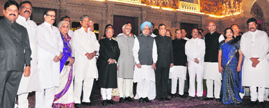 President Pranab Mukherjee and Prime Minister Manmohan Singh pose with new ministers after the swearing-in ceremony in New Delhi on Sunday.