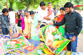 Devotees buy posters on Valmiki Jayanti at Sector 24, Chandigarh, on Monday.