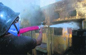 A fireman douses flames at the hosiery unit in Ludhiana on Tuesday