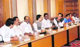 Ministers during their meeting with PM Manmohan Singh in New Delhi on Thursday