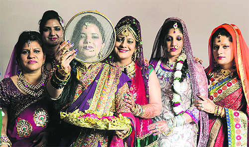Women celebrate Karva Chauth at Geetanjali Ladies Club in Ludhiana on Friday.