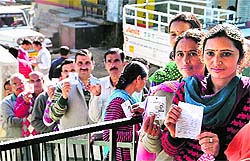 Voters wait for their turn at a poll booth in Shimla on Sunday