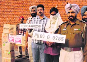 The police shows fake number plates seized from the vehicle of the liquor smuggler in Ludhiana on Sunday