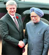 PM Manmohan Singh greets his Canadian counterpart Stephen Harper in New Delhi on Tuesday.