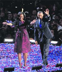 THANK YOU! US President Barack Obama and First Lady Michelle Obama greet the crowd after his victory, in Chicago on Wednesday