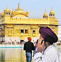 A devotee talks on cellphone on the Golden Temple premises.