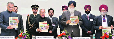 (L-R) Punjab Governor Shivraj Patil, President Pranab Mukherjee, Chief Minister Parkash Singh Badal and Punjab Agricultural University Vice-Chancellor BS Dhillon release a publication to mark the institutes golden jubilee in Ludhiana on Tuesday.