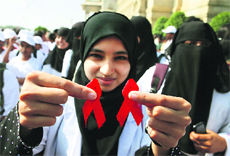 A student holds red ribbons at an event to mark World AIDS Day in Bangalore on Saturday.