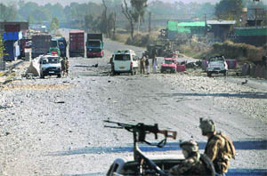 Afghan security forces inspect the site of attack in Jalalabad on Sunday. 