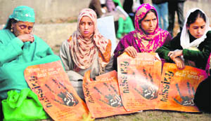 Relatives of missing persons hold banners during a protest in Srinagar on Sunday. 