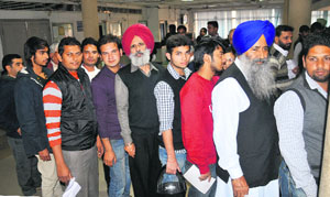 Residents queue up to collect their RCs at the office of the Registration and Licensing Authority at Sector 17 in Chandigarh on Monday.