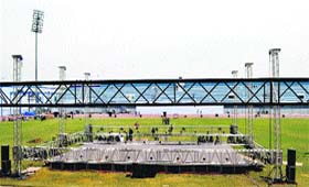 Workers install a stage