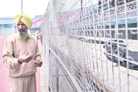 Workers install baricades at Guru Nanak Stadium in Ludhiana