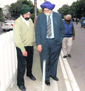 Mayor Harcharan Singh Gohalwaria inspects the ongoing paint work on Ferozepur Road in Ludhiana on Thursday