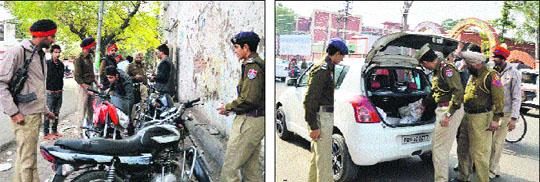 The police checks the documents of youths found roaming near the Khalsa College for Women in Ludhiana on Monday.