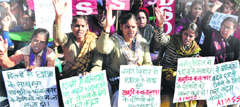 Women shout slogans during a protest following the gang- rape of a student in New Delhi, on Tuesday. Tribune photo