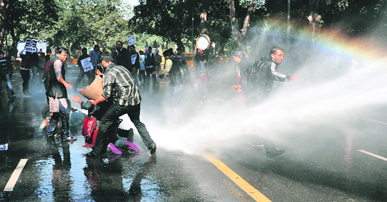 The police uses water cannons to disperse protesters outside Delhi Chief Minister Sheila Dikshits residence on Wednesday.
