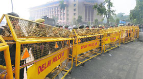 Riot police keep a watch as the road leading towards the landmark India Gate monument is sealed following clashes between demonstrators and police in New Delhi on Monday.