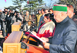 Urmila Singh, Governor, Himachal Pradesh, administers the oath of office and secrecy to Virbhadra Singh as Chief Minister at the historic Ridge in Shimla on Tuesday.