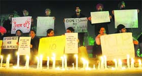 Residents stage a candle-light vigil in memory of the Delhi gang rape victim at Sector 17 Plaza in Chandigarh on Saturday