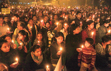 People take part in a candlelight vigil in New Delhi to mourn the death of the gang-rape victim.
