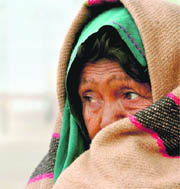 A woman tries to protect herself from chill in Bikaner. 