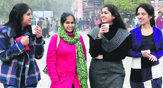 Girls sip tea to kill the chill; and residents enjoy a cold Monday afternoon at Sector 17 in Chandigarh.