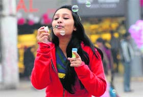 A girl blows bubbles at Sector 17 as the sun finally showed up in the sky in Chandigarh on Thursday afternoon.