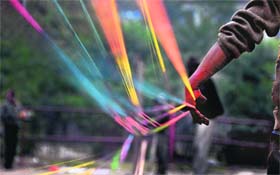 A worker prepares kite strings at Darasi Ground in Ludhiana on Saturday.