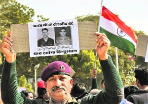 An ex-serviceman participates in a protest against the killing of two Indian soldiers in Bikaner on Thursday. 
