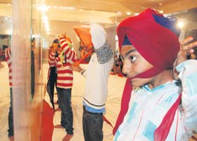 Keeping with tradition: Students take part in a turban-tying competition at the Nada Sahib gurdwara in Panchkula on Monday