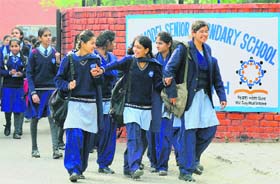 Students leave Government Model Senior Secondary School, Sector 16, on the first day of the school after the winter vacation in Chandigarh on Monday