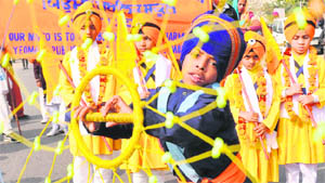 A devotee displays gatka skills during a nagar kirtan taken out ahead of the birth anniversary of Guru Gobind Singh at Phase VII in Mohali on Wednesday.