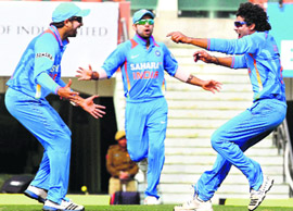 R Jadeja (R) celebrates with Yuvraj Singh (L) and Virat Kohli after dismissing England batsman C. Kieswetter during the 3rd ODI in Ranchi on Saturday.