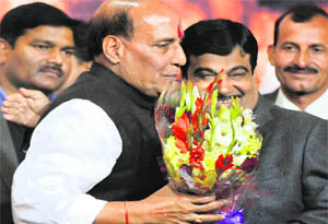 New BJP chief Rajnath Singh is greeted by outgoing president Nitin Gadkari in New Delhi on Wednesday. 