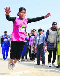 Children participate in the long jump during the block-level school games at Karan Stadium in Karnal on Saturday.