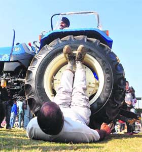 Pargat Singh lifts a tractor with his legs