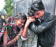 Family members mourn the death of their relatives in the Allahabad railway station stampede, on Monday.