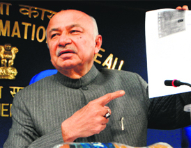 Home Minister Sushilkumar Shinde shows the Speed Post receipt.