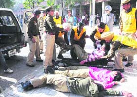 The police team takes the supposedly injured persons for medical help during the mock drill at the PG Government College, Sector 42, Chandigarh, on Wednesday