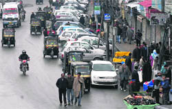 People walk in a street after curfew was lifted from Srinagar and some other parts of the Kashmir valley on Saturday.