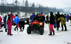 Tourists make the most of the fresh snowfall at Nehru Kund near Manali on Saturday.