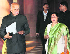 Union Home Minister Sushilkumar Shinde with BJP leader Sushma Swaraj in New Delhi on Wednesday. 