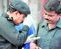 Members of the NSG inspect the evidence collected from the blast site in Hyderabad on Friday. 