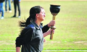 Senior players carry a torch during the GADVASU athletics meet in Ludhiana on Wednesday