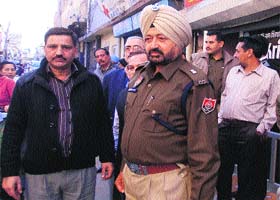 The victim, Surinder Kumar (left), with a police official at the crime spot
