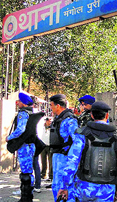 RAF personnel stand guard outside a police station in Delhis Mangolpuri area on Saturday